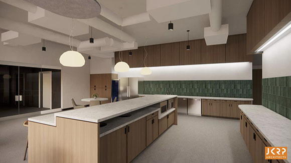 A modern office kitchen featuring a long marble-topped island, wood cabinets, and green tiled backsplash.