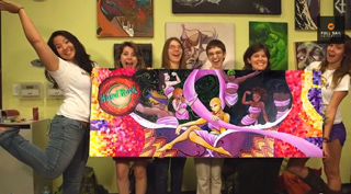 Six women smiling and posing behind a large, vibrant, colorful painting of several women.