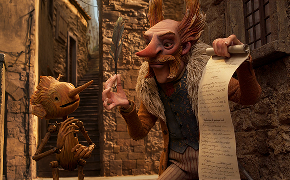 An animated man with large ears holds a feather quill and a long scroll, looking at a small wooden creature.