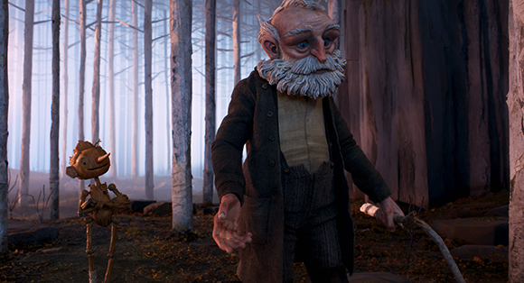 An elderly man with a white beard and a small wooden puppet standing in a misty forest.