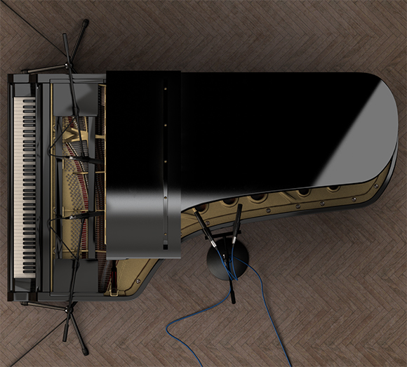 Top-down view of a black grand piano on a herringbone wood floor with two microphones positioned near the strings.