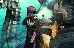 A pirate in a dark coat and red bandana aims a smoking flintlock pistol near a giant tentacle.