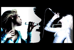 Two high-contrast profiles of a person singing into microphones against a black background.