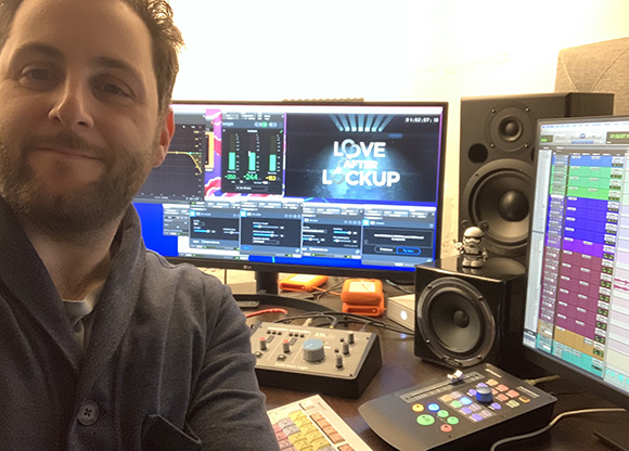 A man in a blue shirt smiles next to computer monitors displaying audio software and the title 'Love After Lockup'.