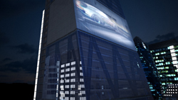A tall building at night featuring a large, bright advertisement of a car on its upper facade.