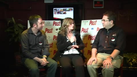 Three people sit on stage in front of a Post backdrop and a television screen.