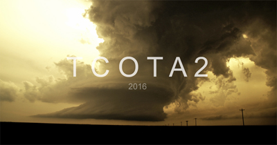 Large, dark storm clouds loom over a flat horizon under a golden sky with text reading TCOTA2 2016.