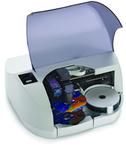 A white laboratory machine with an open translucent lid revealing internal mechanical and electronic components.