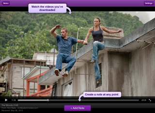 A man and woman leap between concrete rooftops in a lush, tropical setting.