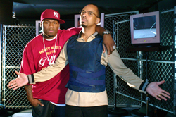 A man in a red cap and shirt stands with his arm around a man wearing a blue tactical vest.