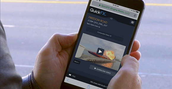 A person's hands holding a smartphone showing the QuickFX app interface with a video preview.