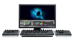 A computer monitor displaying video editing software flanked by two control consoles and a central control panel.