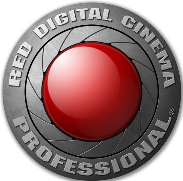 Circular metallic logo with a large red button in the center and text around the rim.