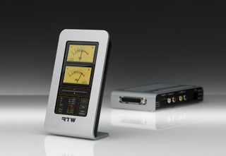 A vertical meter with two analog displays and a horizontal rack-mount audio processor.