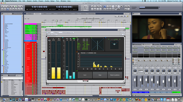 A computer screen showing a complex digital audio workstation with mixing sliders, meters, and a video window.