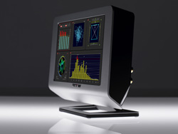 A silver and black computer monitor displaying colorful graphs and data charts on a dark background.