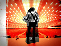 Silhouette of a musician with a guitar against a bright, red-lit stadium background.