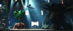 A green frog in a floral shirt sits next to a large, dark figure in a wide-brimmed hat under shafts of light.