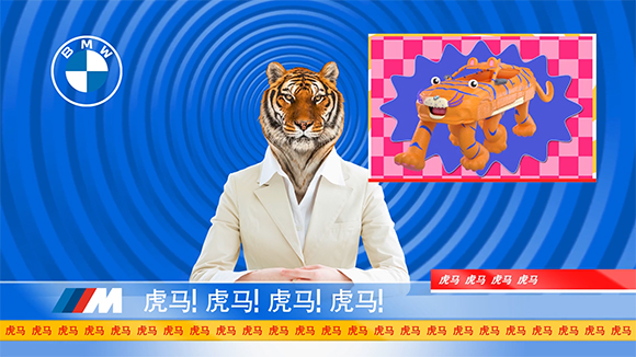 A person in a white suit with a tiger head sits before a blue swirl background with BMW and M logos.