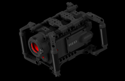 A black RED digital cinema camera encased in a rugged protective cage against a black background.