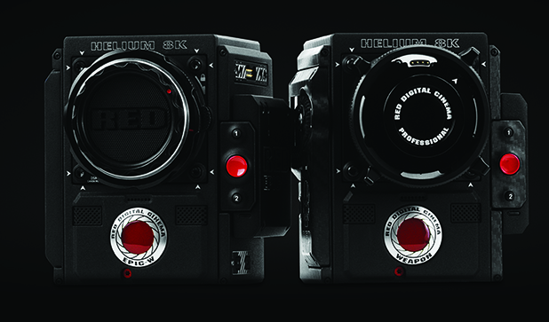 Two black RED Helium 8K digital cinema cameras positioned face-to-face against a black background.
