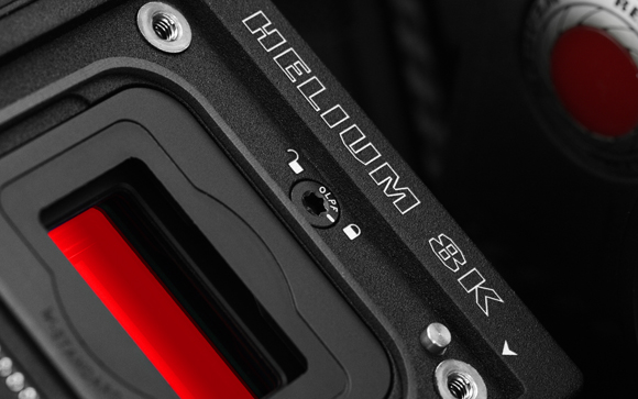 Close-up of a black textured metal device casing with the text HELIUM 8K engraved in white.