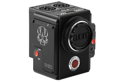 A compact black RED digital cinema camera with a skull logo and a large lens mount.