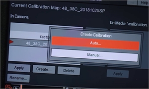 A digital screen displaying a 'Create Calibration' pop-up menu with 'Auto...' and 'Manual...' options.