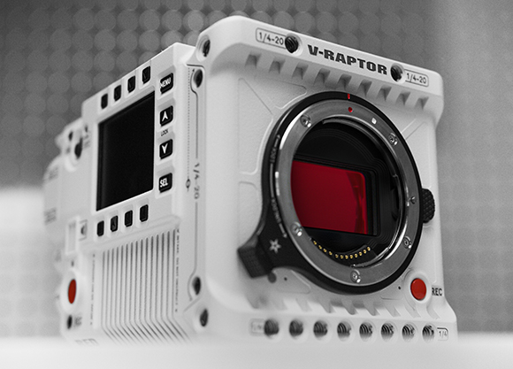A close-up, angled view of a white V-RAPTOR digital cinema camera body with a visible sensor.