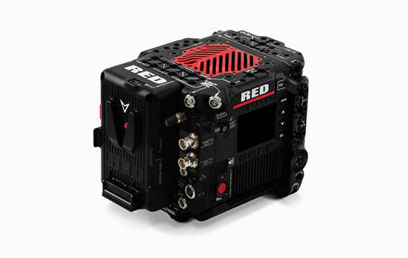 A black RED digital cinema camera with red accents and various ports and buttons.