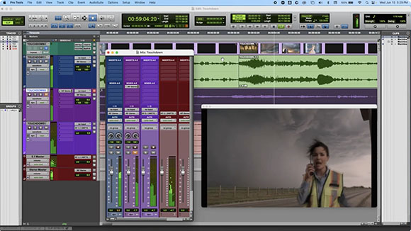 Pro Tools software interface showing audio mixer tracks and a video window of a person in a safety vest.