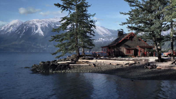 A wooden cabin sits on a rocky shore by a lake with snow-covered mountains under a blue sky.