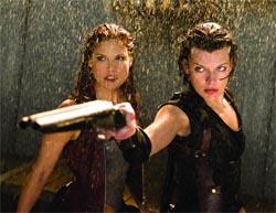 Two women with wet hair stand in the rain; one points a handgun toward the camera.