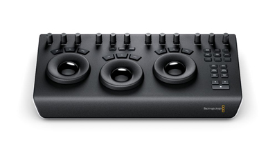 A black video editing control panel with three large trackballs, various knobs, and buttons.