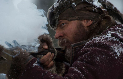 A bearded man in fur clothing aims a weapon through thick white smoke in a snowy environment.