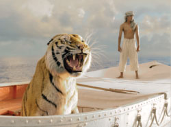 A large tiger roars in the foreground of a small boat while a shirtless man stands behind it.