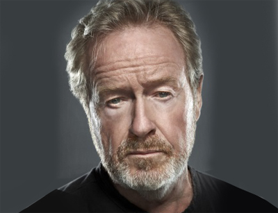 Close-up portrait of an older man with light hair, blue eyes, and a graying beard against a dark gray background.