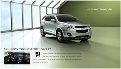 A silver Chevrolet Equinox parked in a bright, modern showroom with large windows.