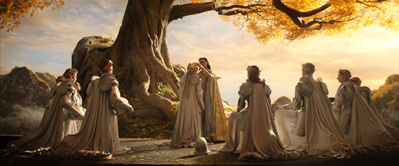 People in ornate white and gold robes kneel in a circle around a large tree under a golden sunset sky.