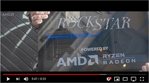 A video screen displaying computer components with Rockstar and AMD Ryzen Radeon logos.