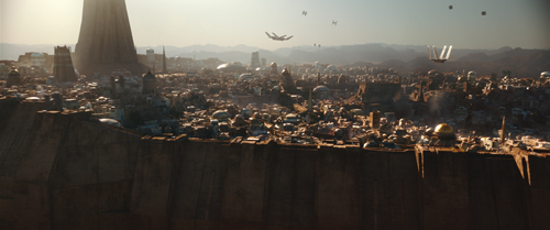 A vast desert city with domes and towers under a hazy sky with several flying crafts.
