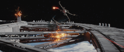 Two starfighters fly over a large, partially destroyed space station in deep space.