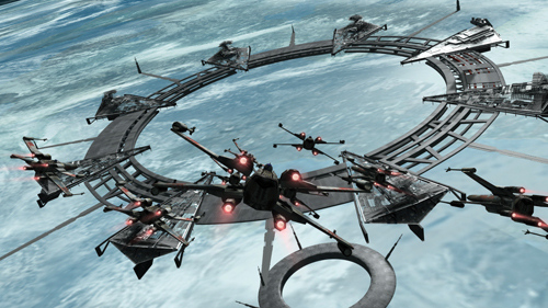 Several dark starfighters fly through and around a large metallic ring structure in orbit above a blue planet.