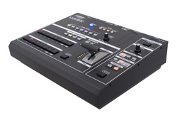 A black electronic DJ controller with sliders, knobs, and buttons on a white background.