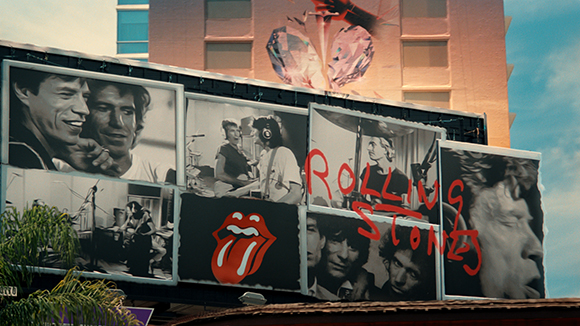 Billboard with black and white band photos, the red tongue logo, and red text reading Rolling Stones.