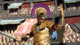 A gladiator in golden armor and a purple-crested helmet raises one hand in a crowded Roman arena.