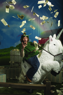 A man in a green tunic rides a white unicorn through falling dollar bills under a rainbow.