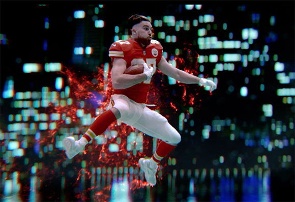 Football player in a red and white uniform jumps through the air against a blurred city skyline background.