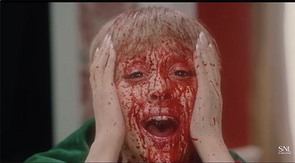 A person with their hands on their face, which is covered in a thick red substance.