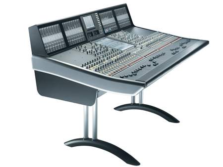 A large digital audio mixing console with numerous faders, knobs, and screens mounted on a silver and black stand.